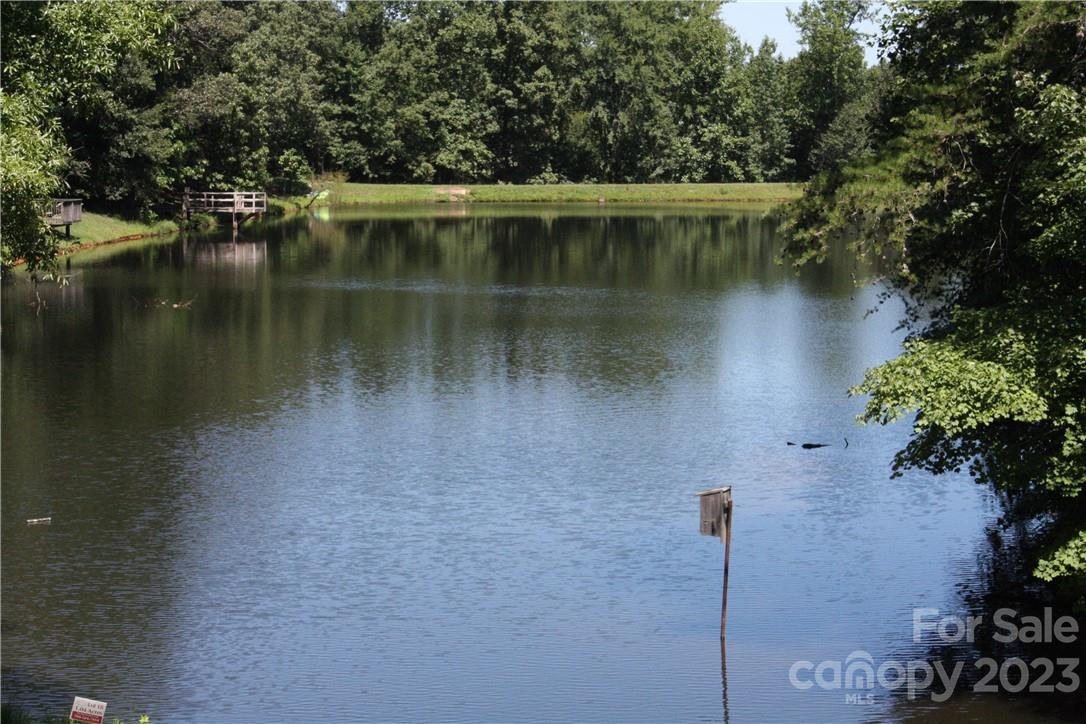 651 Bellegray Road Clover, SC 29710 - Photo 34 of 39 a view of a lake with a house in the background