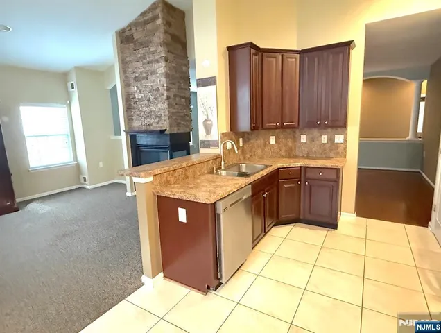 a view of an empty room with a fireplace and a window