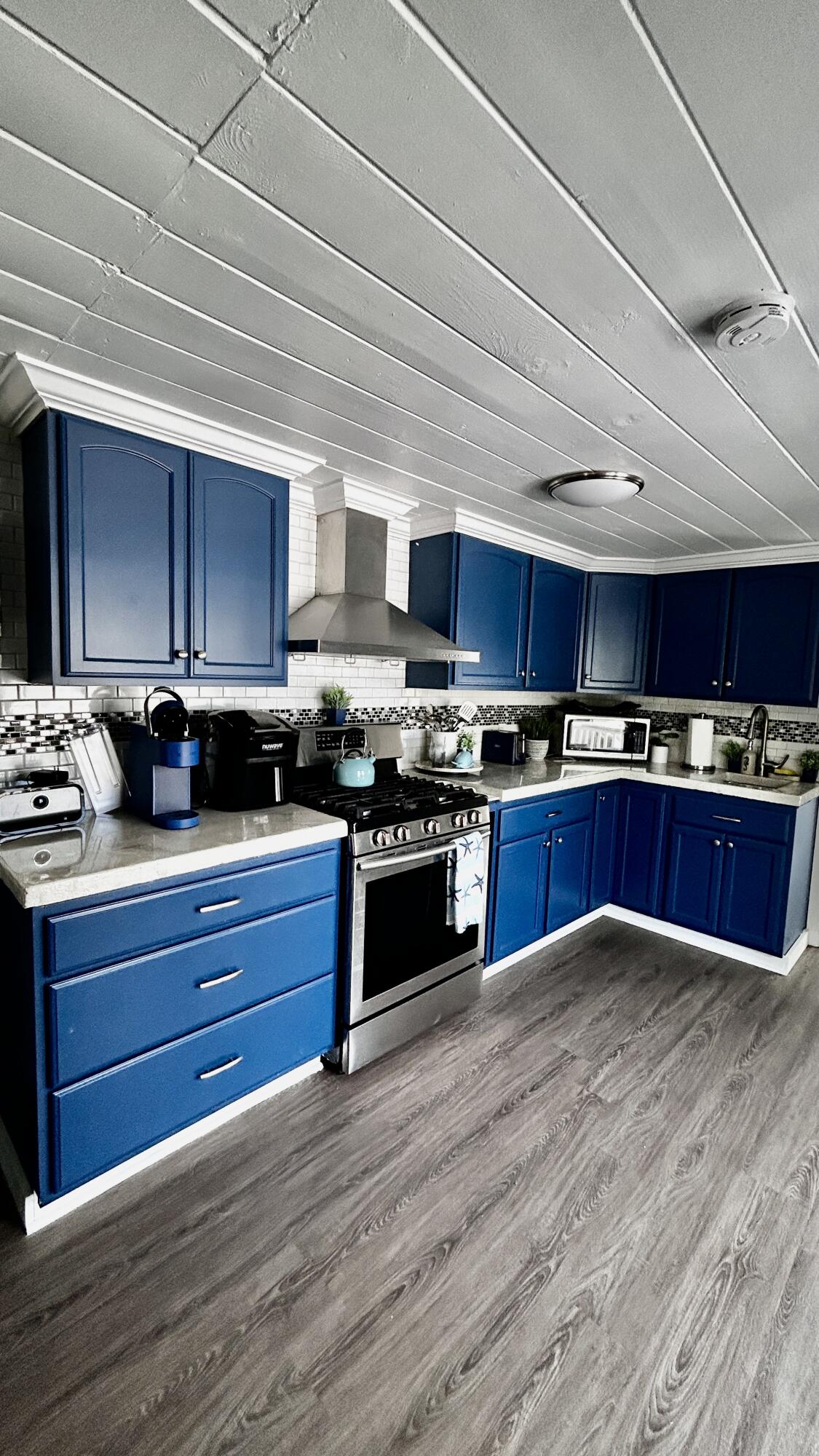 124 South Bay Harbor Drive Key Largo, FL 33037 - Photo 6 of 43 a kitchen with stainless steel appliances granite countertop wooden floors wooden cabinets and a sink