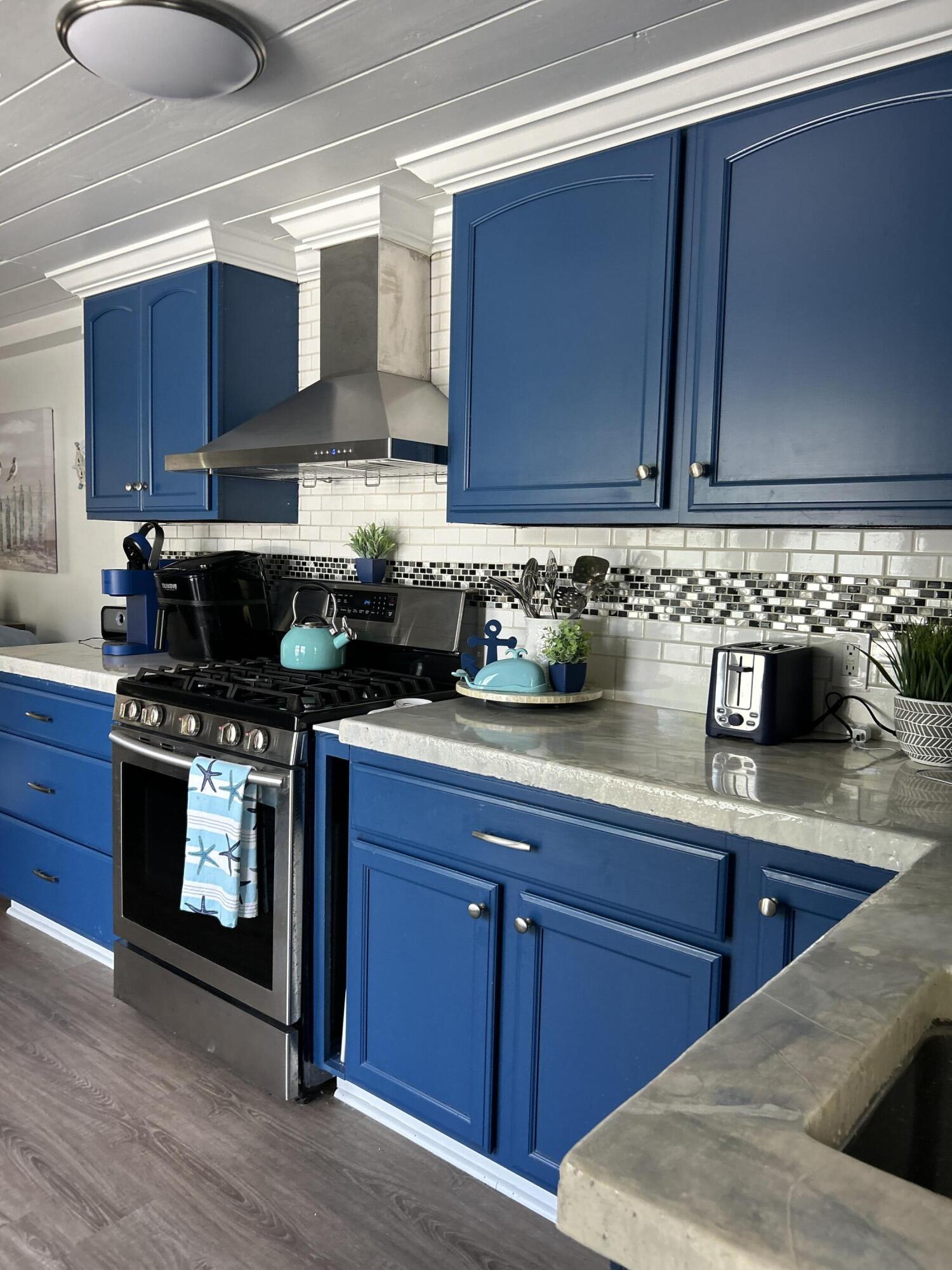 124 South Bay Harbor Drive Key Largo, FL 33037 - Photo 8 of 43 a kitchen with stainless steel appliances granite countertop a sink a stove and cabinets
