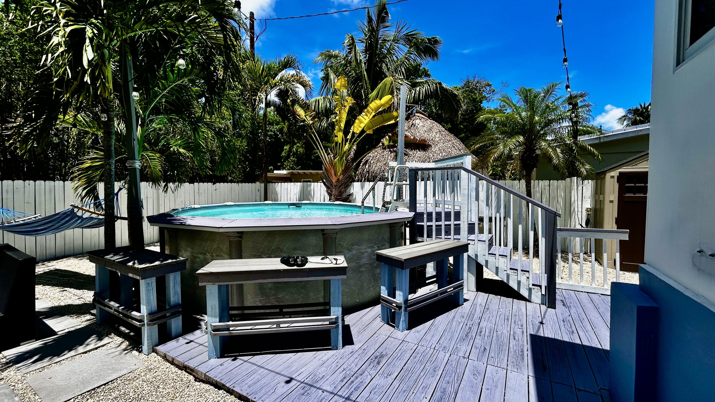 124 South Bay Harbor Drive Key Largo, FL 33037 - Photo 9 of 43 a view of a balcony with chairs