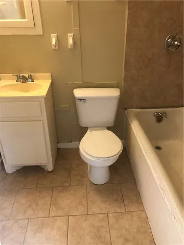 a white toilet sitting next to a bathroom sink