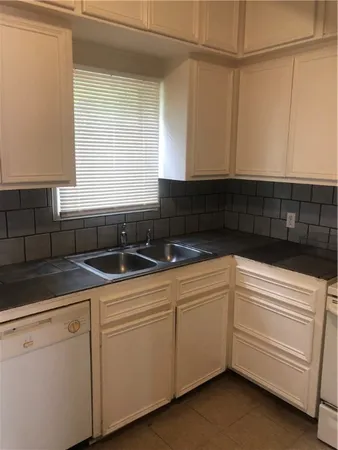 a kitchen with a sink and cabinets