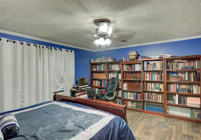 a living room with furniture and a book shelf