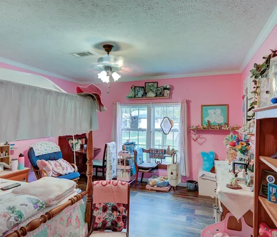 a living room with furniture chess board and a chandelier