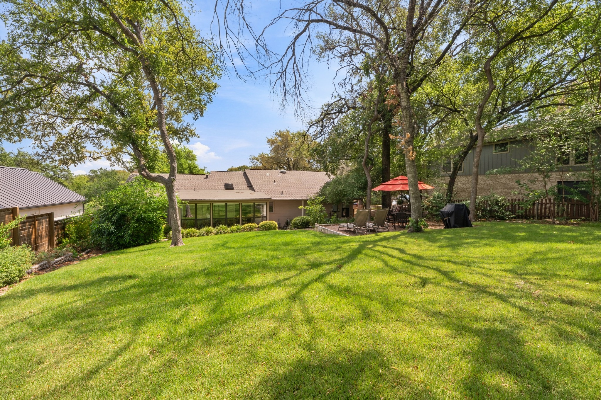 1904 Stoneridge Road Austin, TX 78746 - Photo 33 of 40 Wide lawn and established landscaping with plenty of room for a pool.