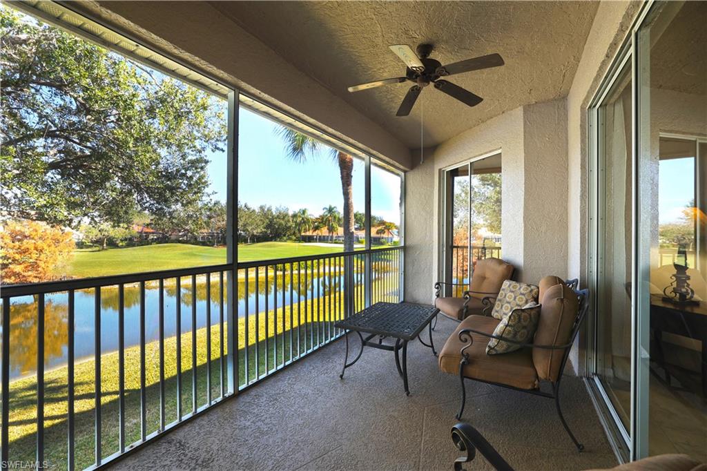 2033 Crestview Way, Unit 104 Naples, FL 34119 - Photo 15 of 24 a living room with furniture and a large window