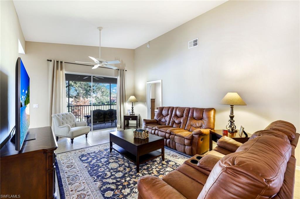 2033 Crestview Way, Unit 104 Naples, FL 34119 - Photo 2 of 24 a living room with furniture and a flat screen tv