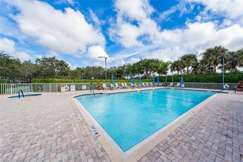 2033 Crestview Way, Unit 104 Naples, FL 34119 - Photo 21 of 24 a view of a swimming pool and an outdoor space