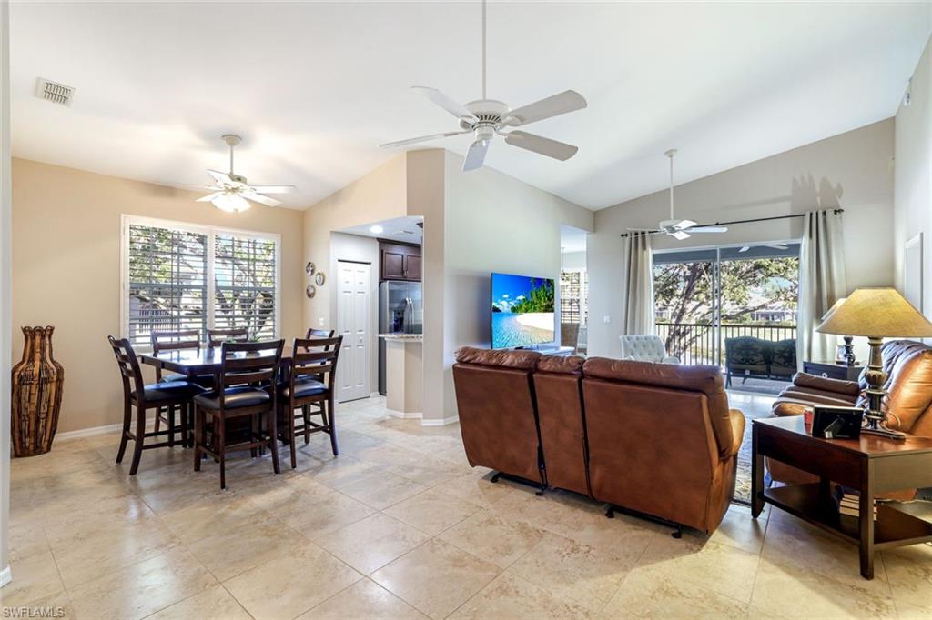 2033 Crestview Way, Unit 104 Naples, FL 34119 - Photo 3 of 24 a view of a dining room and livingroom with furniture window and outside view