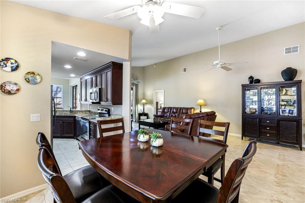 2033 Crestview Way, Unit 104 Naples, FL 34119 - Photo 6 of 24 a view of a dining room with furniture and window