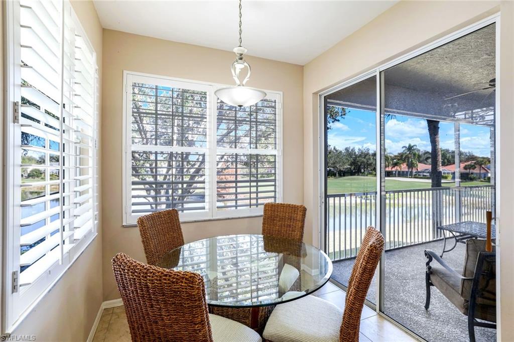 2033 Crestview Way, Unit 104 Naples, FL 34119 - Photo 7 of 24 a view of a dining room with furniture window and outside view