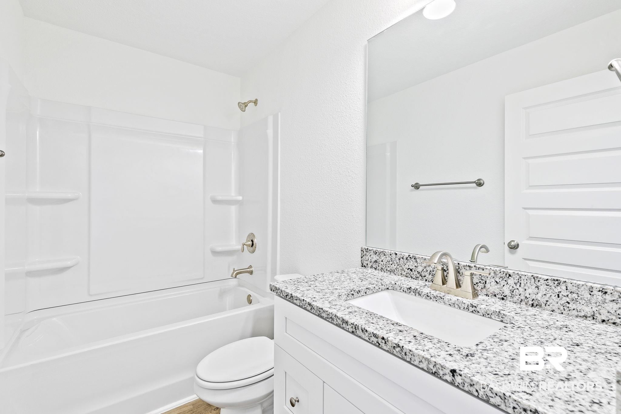16014 Alabama Avenue Silverhill, AL 36576 - Photo 30 of 50 Full bathroom featuring shower / bathtub combination, vanity, and toilet