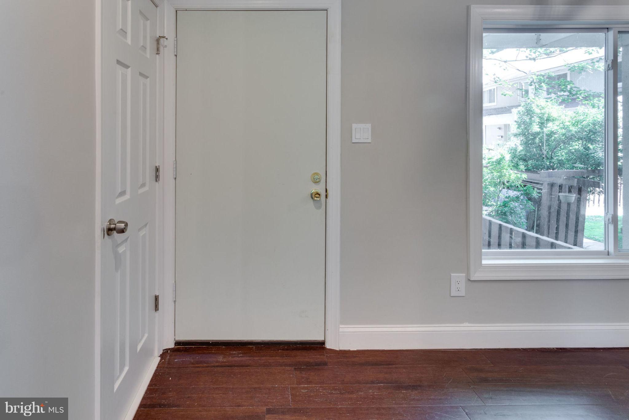 2349 Southgate Square Reston, VA 20191 - Photo 2 of 30 a view of an empty room with wooden floor and a window