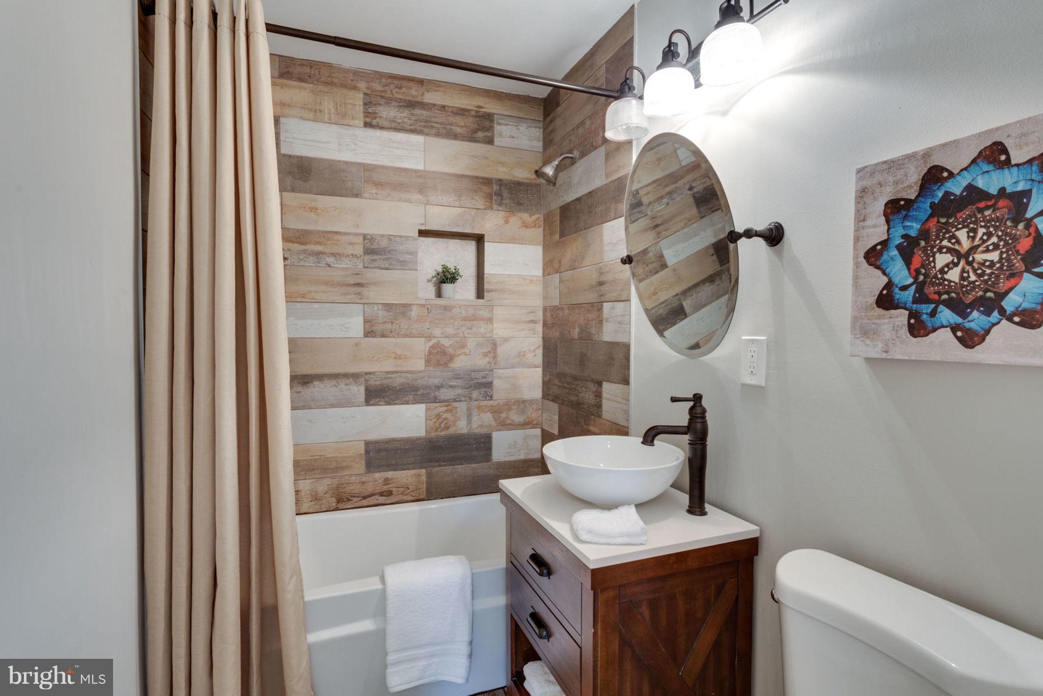 2349 Southgate Square Reston, VA 20191 - Photo 21 of 30 a bathroom with a sink a toilet and a mirror