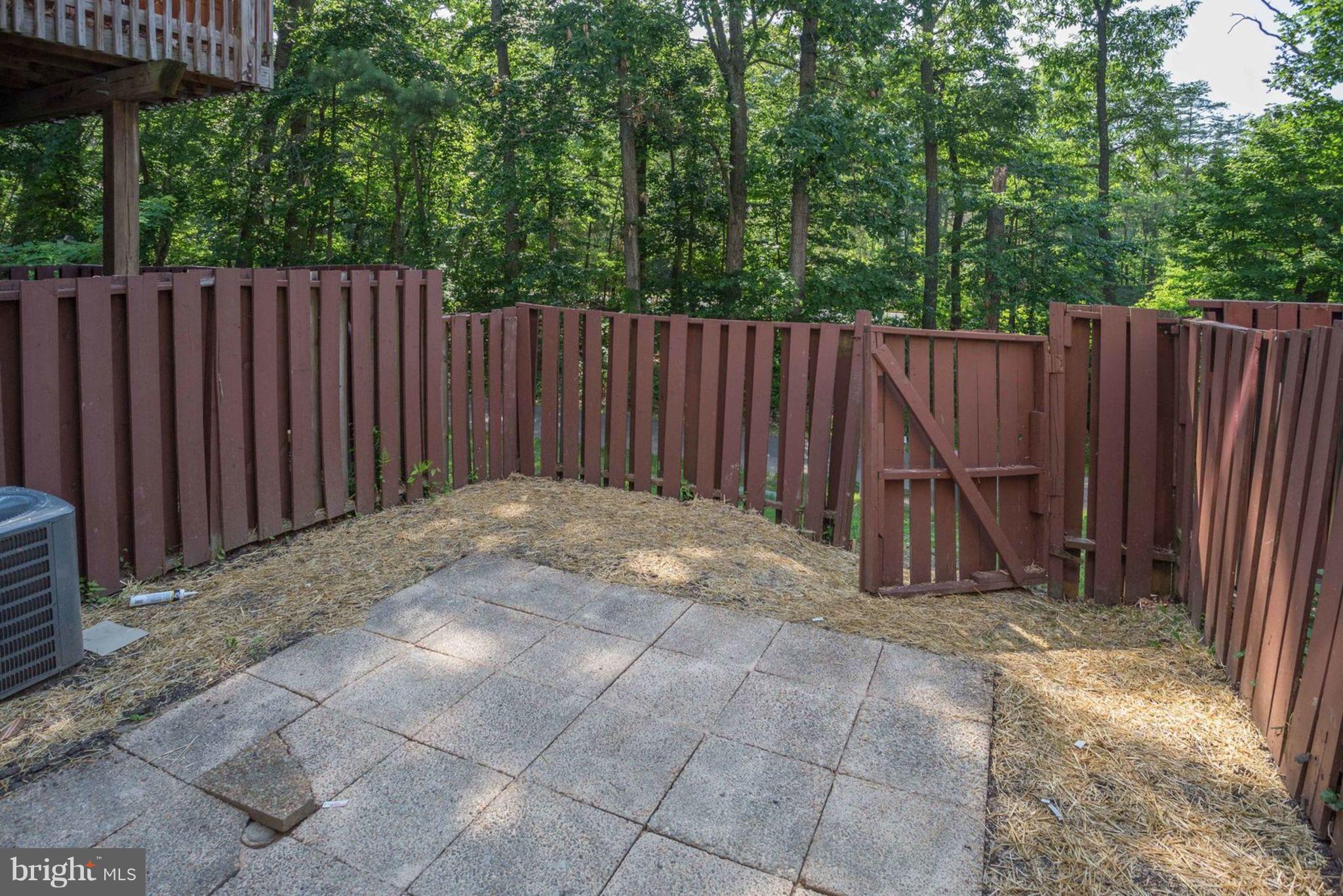 2349 Southgate Square Reston, VA 20191 - Photo 29 of 30 a view of a backyard with wooden fence and a large tree
