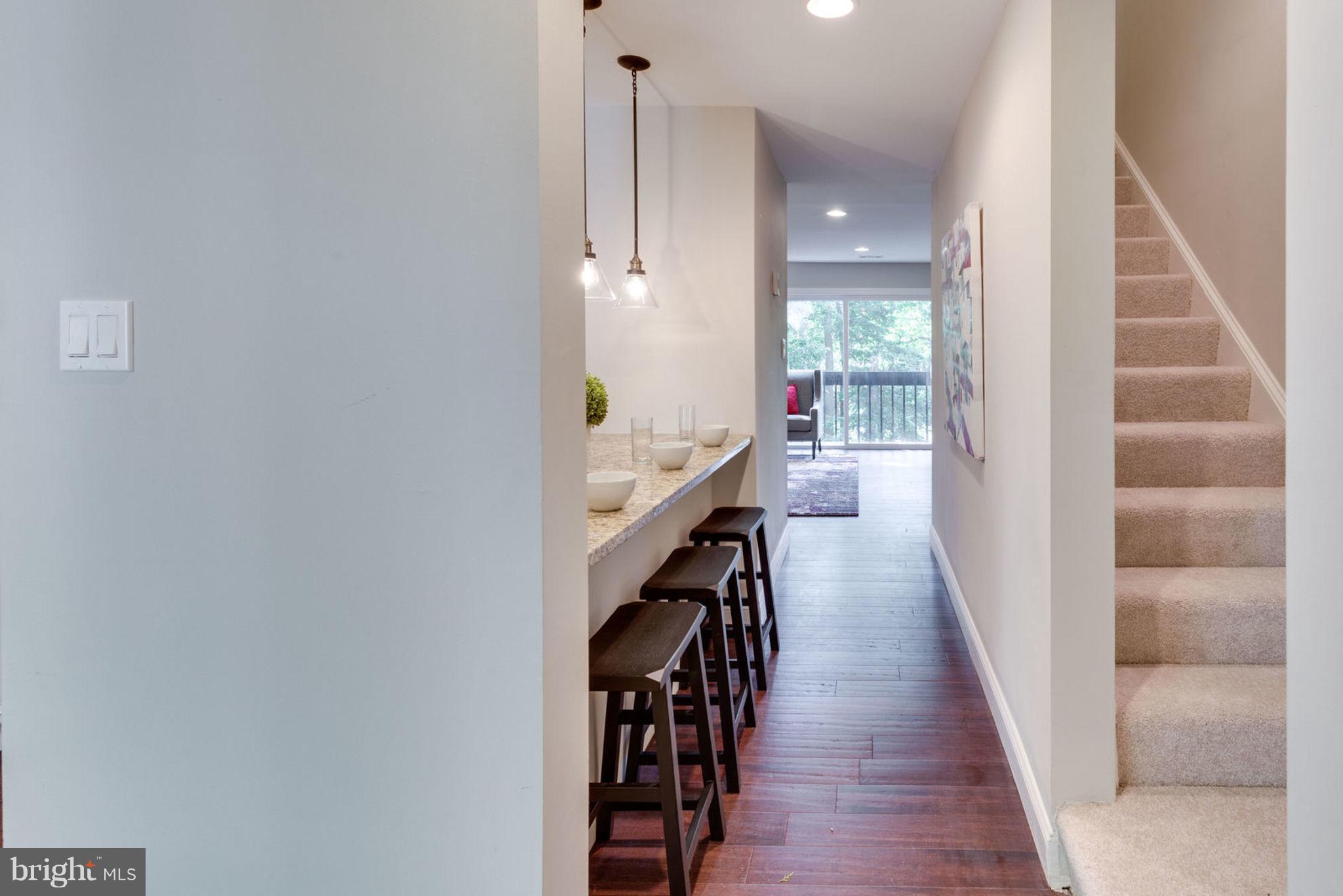 2349 Southgate Square Reston, VA 20191 - Photo 4 of 30 a hallway with wooden floor and staircase