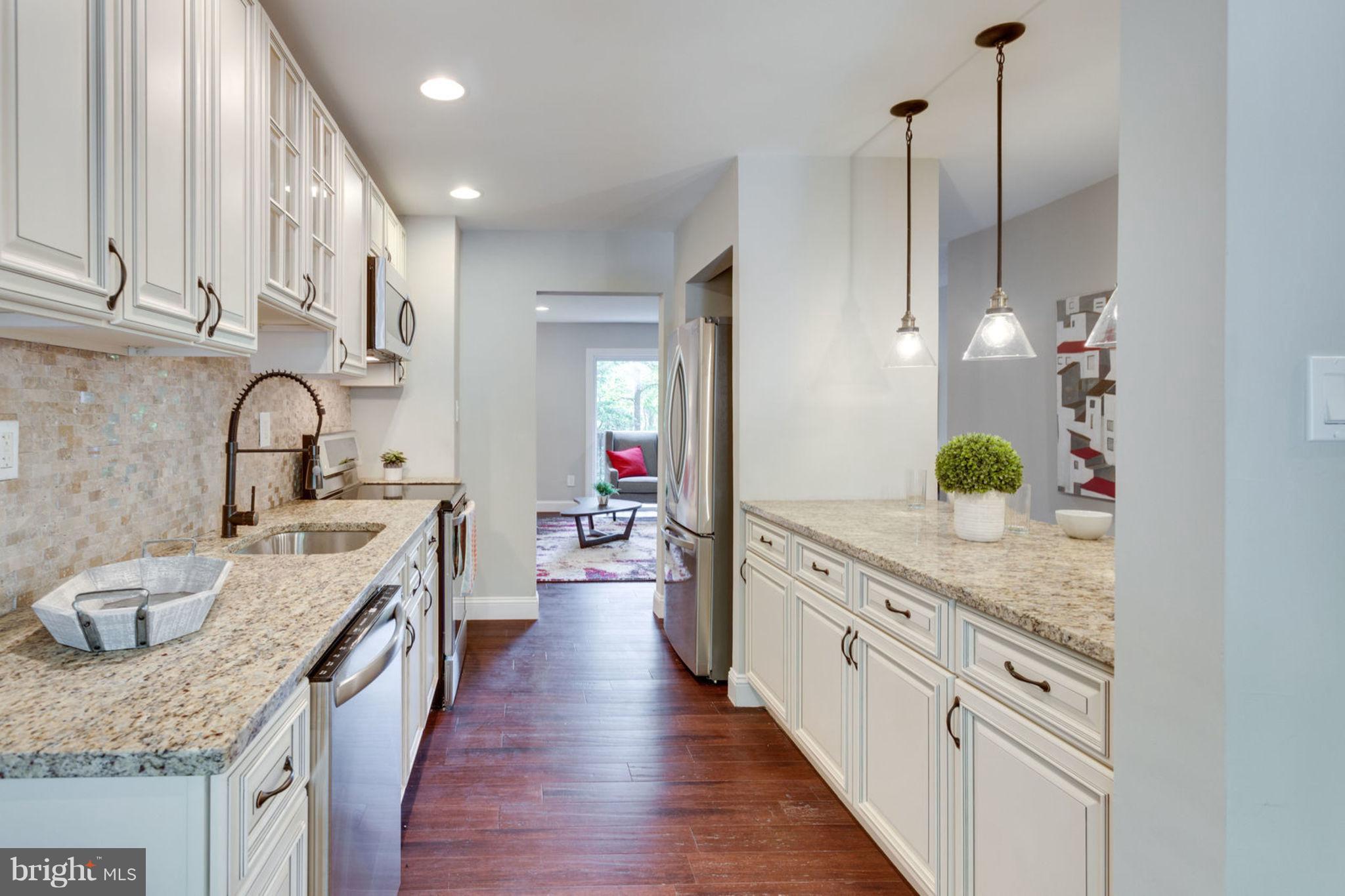2349 Southgate Square Reston, VA 20191 - Photo 8 of 30 a open kitchen with stainless steel appliances granite countertop a sink stove and cabinets