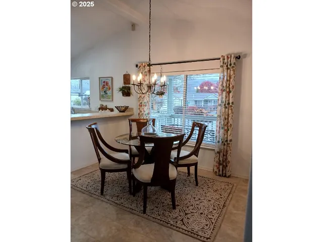 a dining room with furniture and chandelier