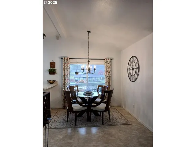 a view of a dining room with a table and chairs