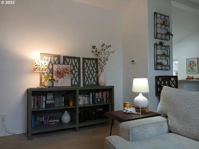 a living room with furniture and a painting on the wall