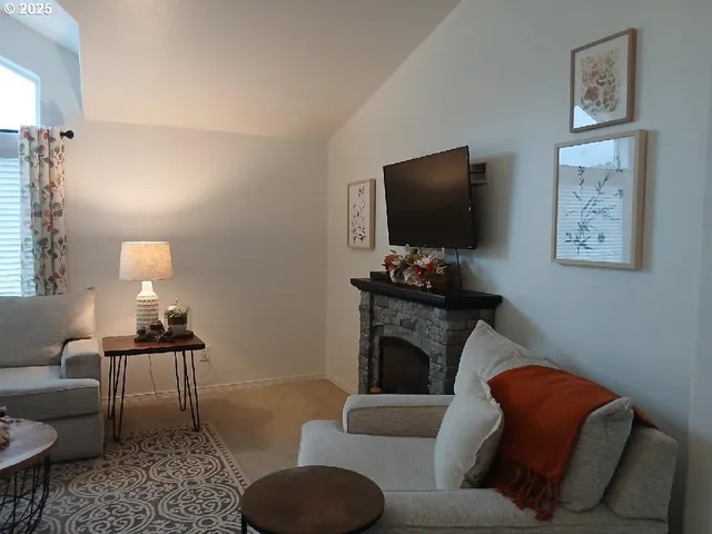 a living room with furniture a rug and a flat screen tv