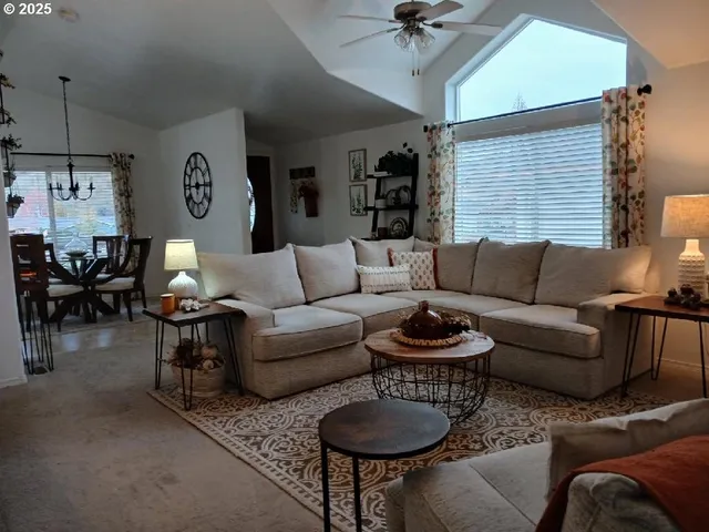 a living room with furniture a rug and a window