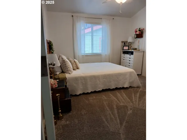 a bedroom with bed and window