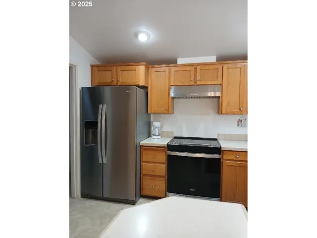 a kitchen with a refrigerator and a stove
