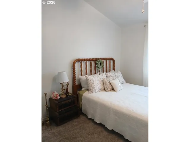 a bed room with a bed and a chair