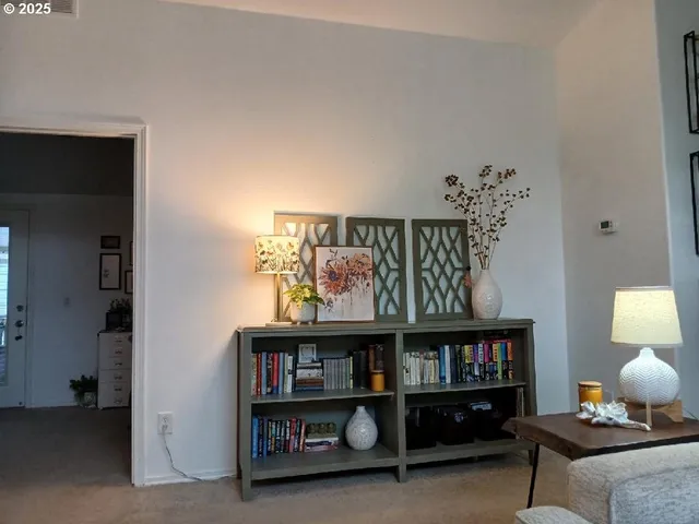 a room with furniture and book shelf