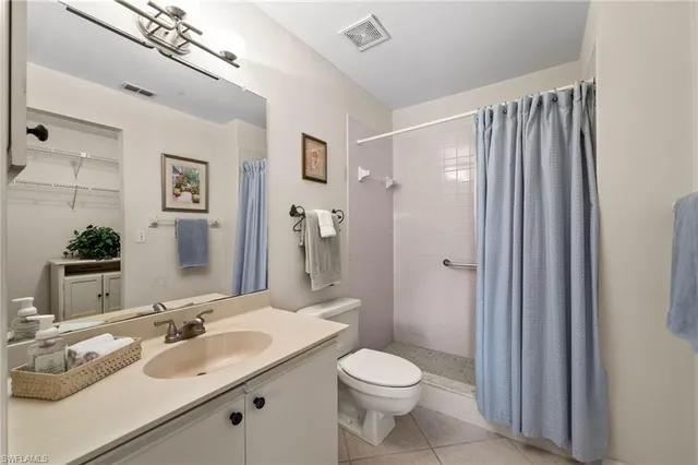 a bathroom with a double vanity sink toilet and shower