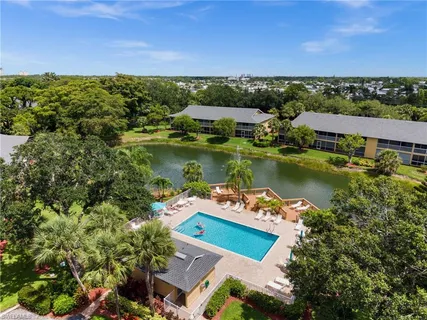 aerial view of a house with a garden and lake view