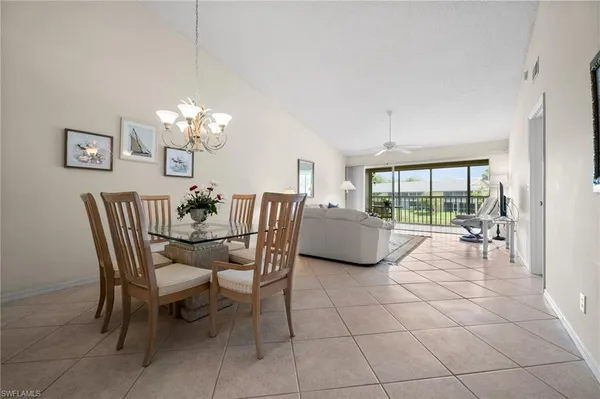 a dining room with furniture and a chandelier