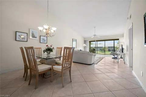 a dining room with furniture and a chandelier