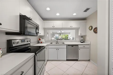 a kitchen with a sink cabinets and wooden floor
