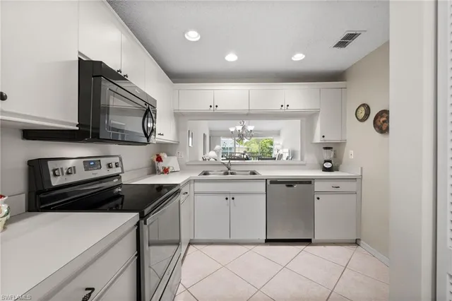 a kitchen with a sink cabinets and wooden floor