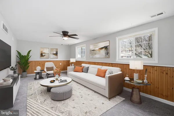 a living room with furniture or couch and a potted plant