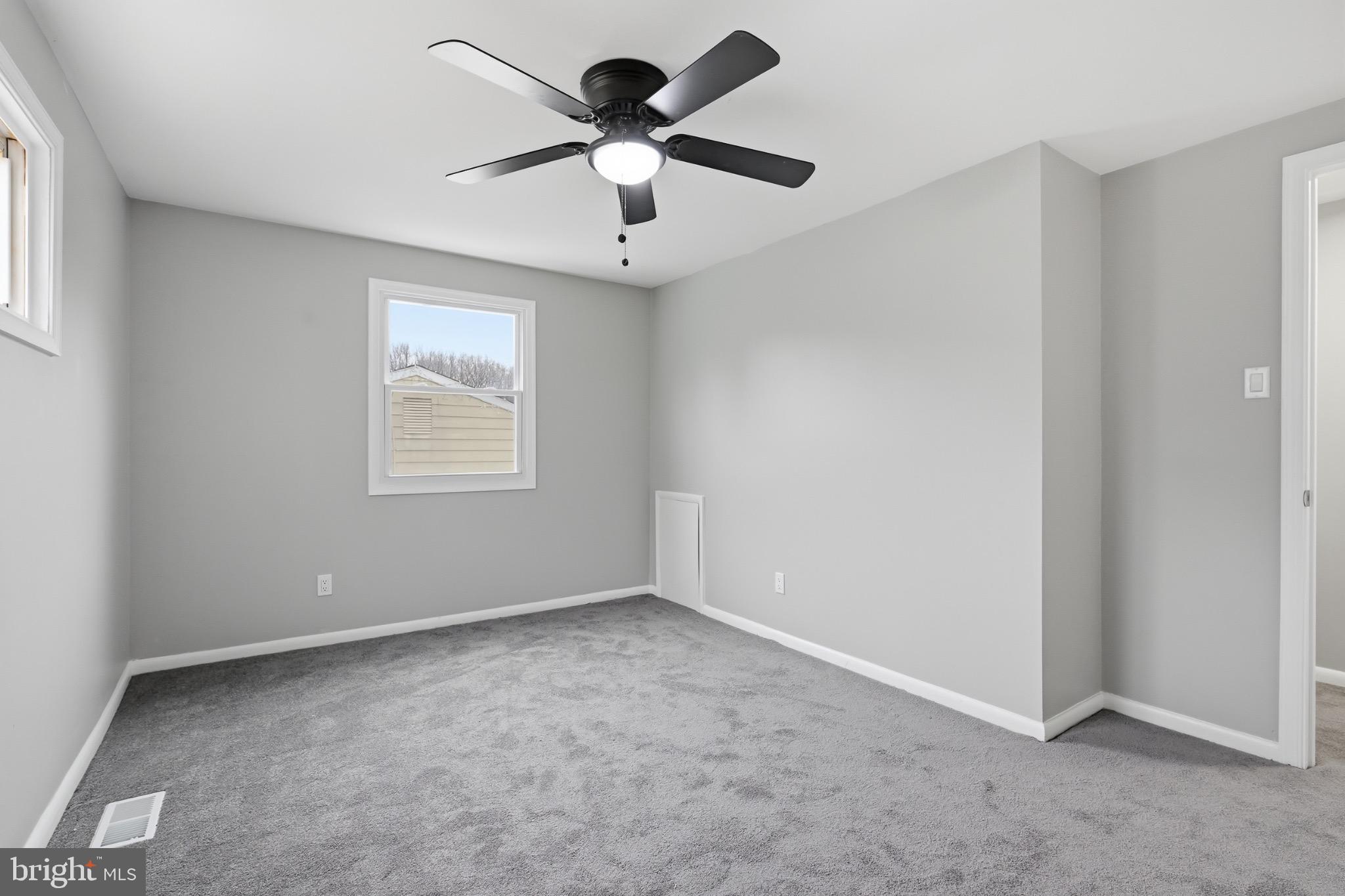 22 Raintree Drive New Castle, DE 19720 - Photo 20 of 29 an empty room with windows and ceiling fan