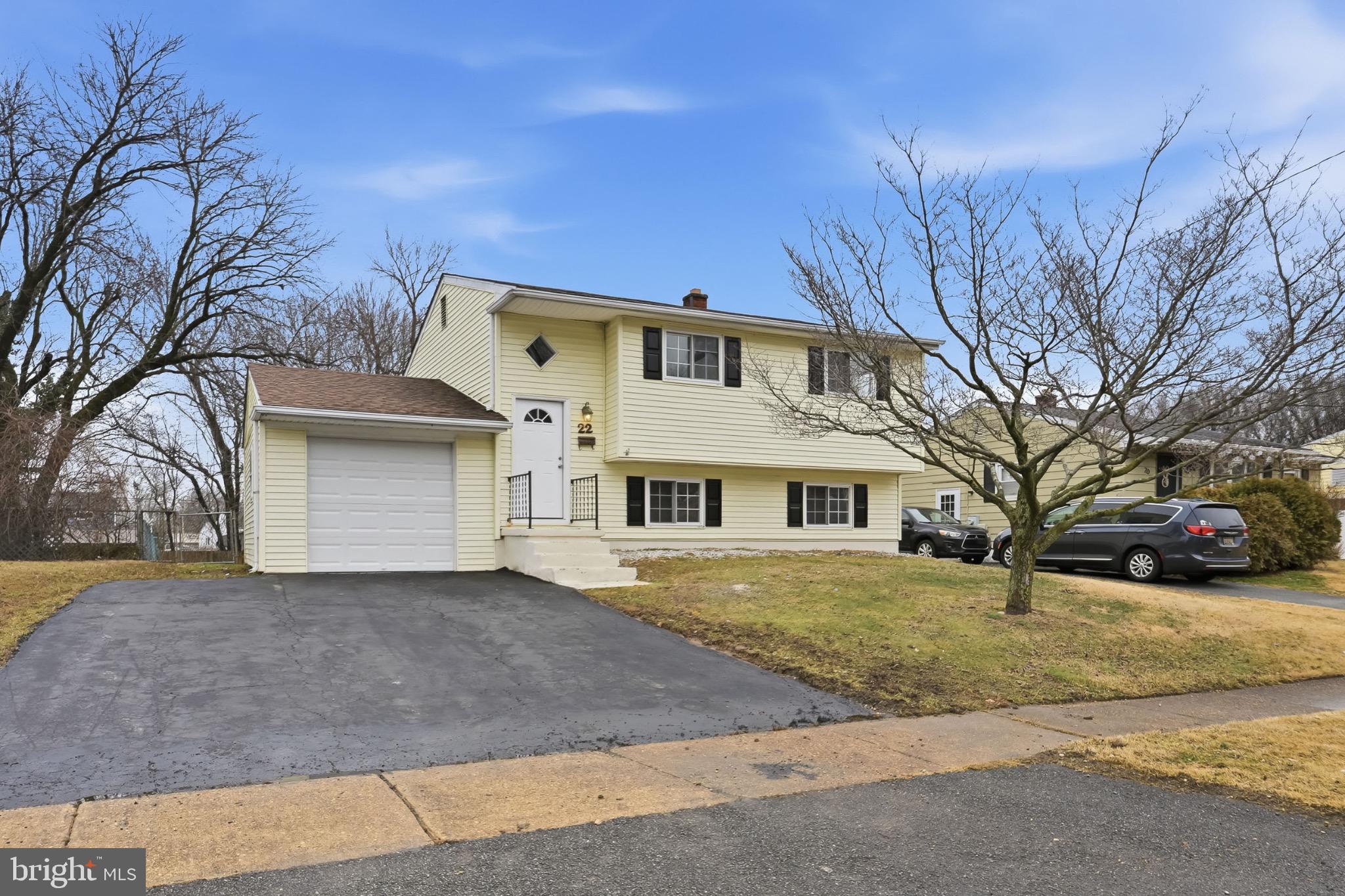 22 Raintree Drive New Castle, DE 19720 - Photo 2 of 29 a front view of a house with a yard and garage