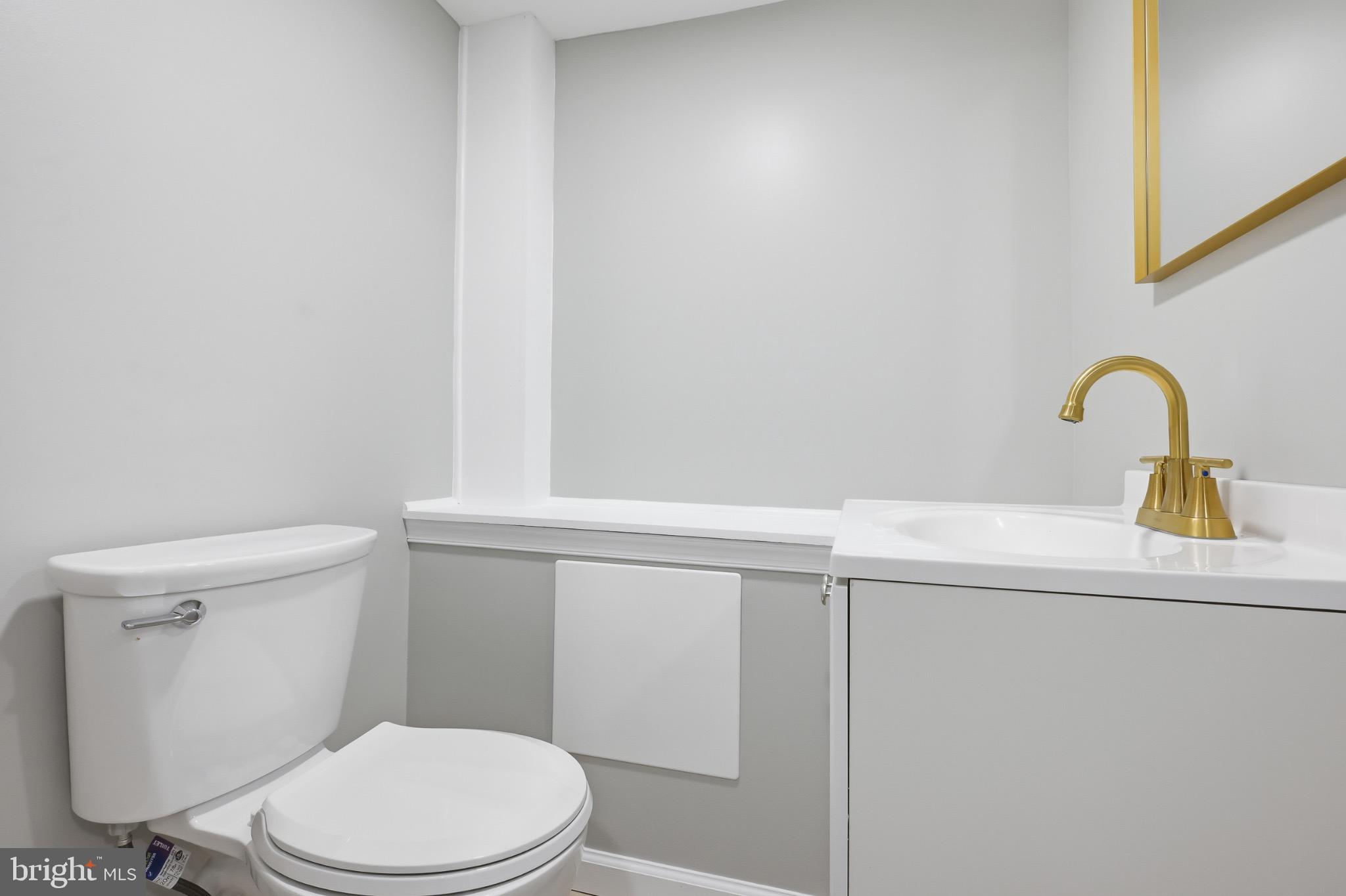 22 Raintree Drive New Castle, DE 19720 - Photo 27 of 29 a bathroom with a sink a toilet and mirror