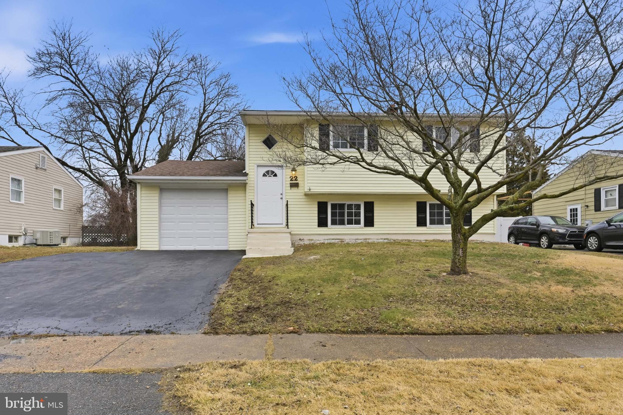 22 Raintree Drive New Castle, DE 19720 - Photo 3 of 29 a white house that has a tree in front of it