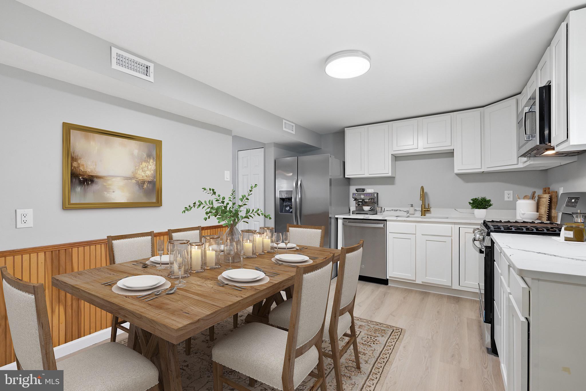 22 Raintree Drive New Castle, DE 19720 - Photo 10 of 29 a open dining room with stainless steel appliances wooden floor dining table and chairs