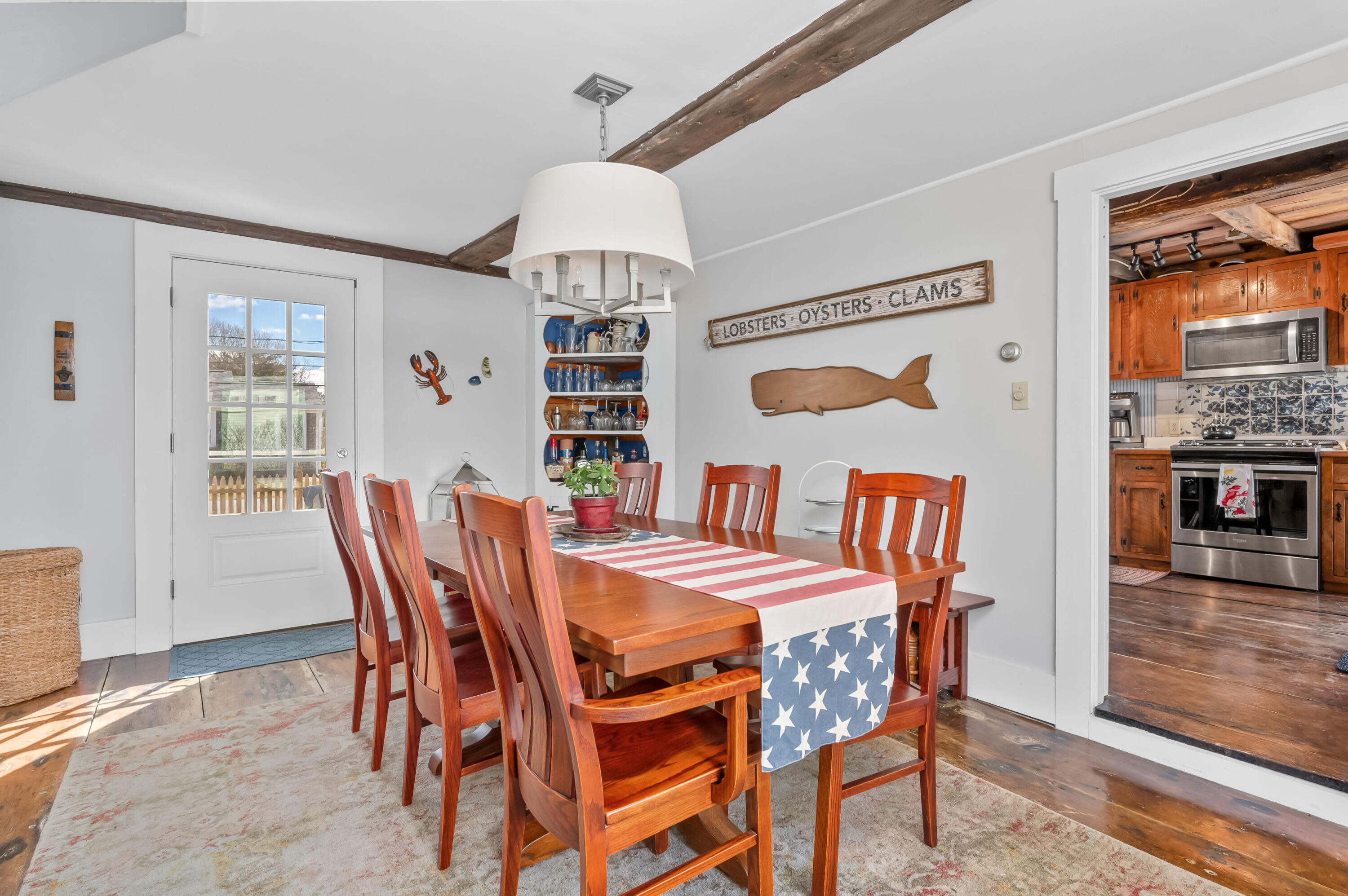 40 Commerce Road Barnstable, MA 02630 - Photo 11 of 43 a view of a dining room with furniture window and wooden floor
