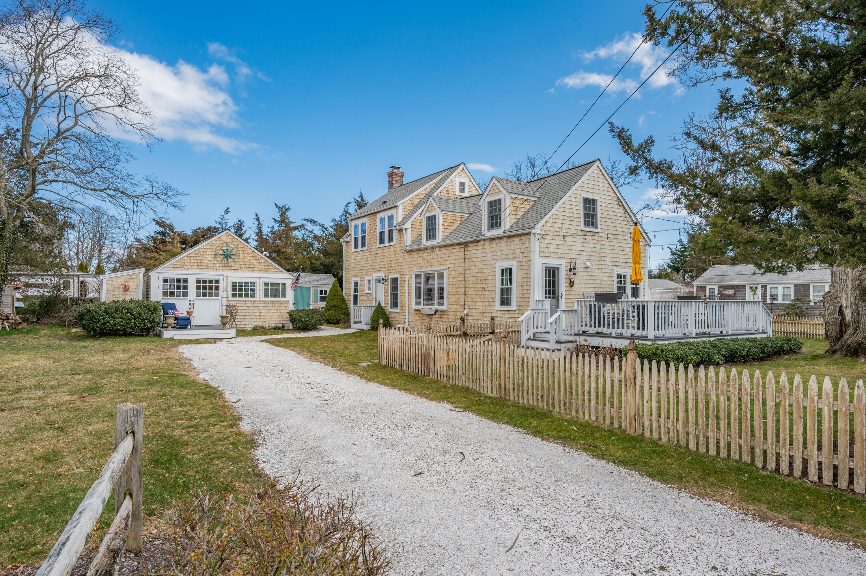 40 Commerce Road Barnstable, MA 02630 - Photo 2 of 43 a front view of a house with a yard