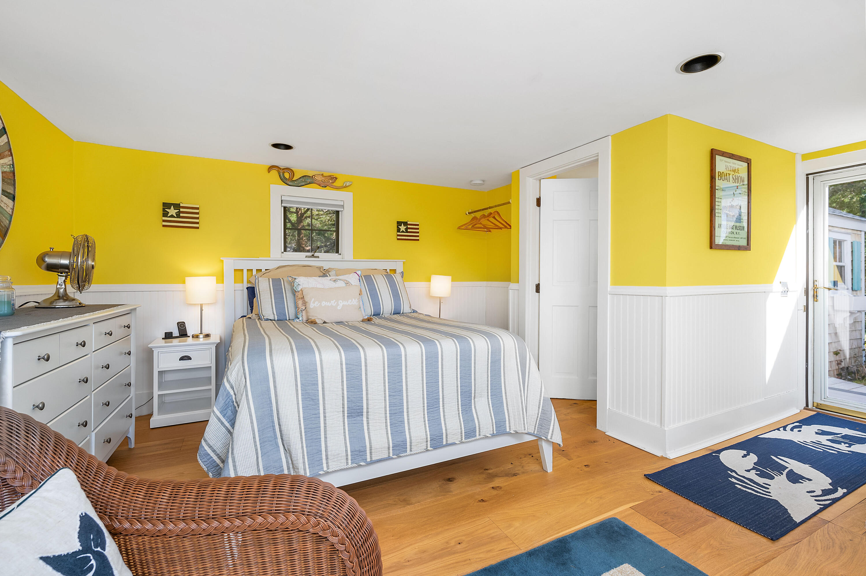 40 Commerce Road Barnstable, MA 02630 - Photo 24 of 43 a bedroom with a bed and wooden floor