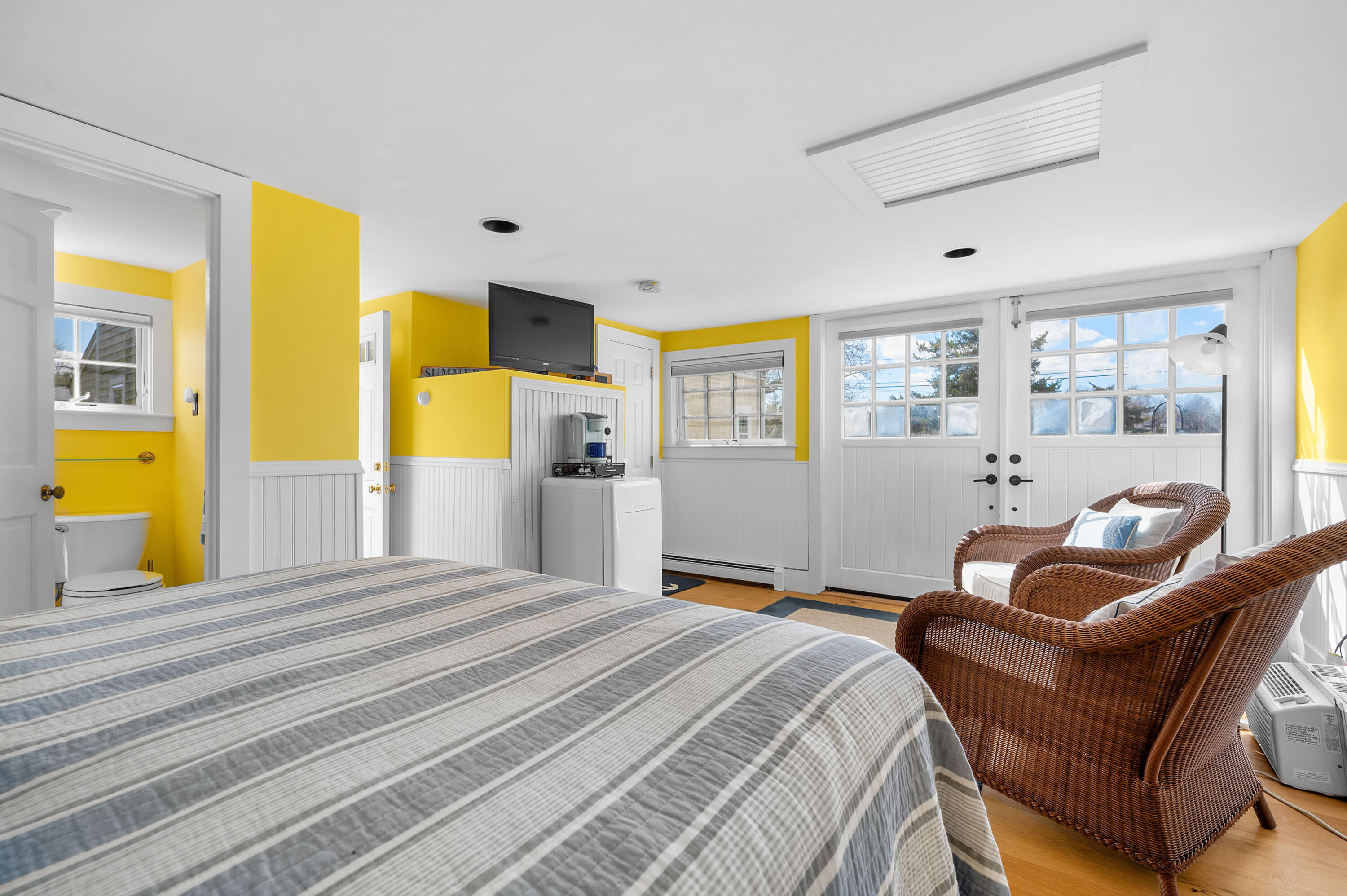 40 Commerce Road Barnstable, MA 02630 - Photo 25 of 43 a bedroom with a bed and wooden floor