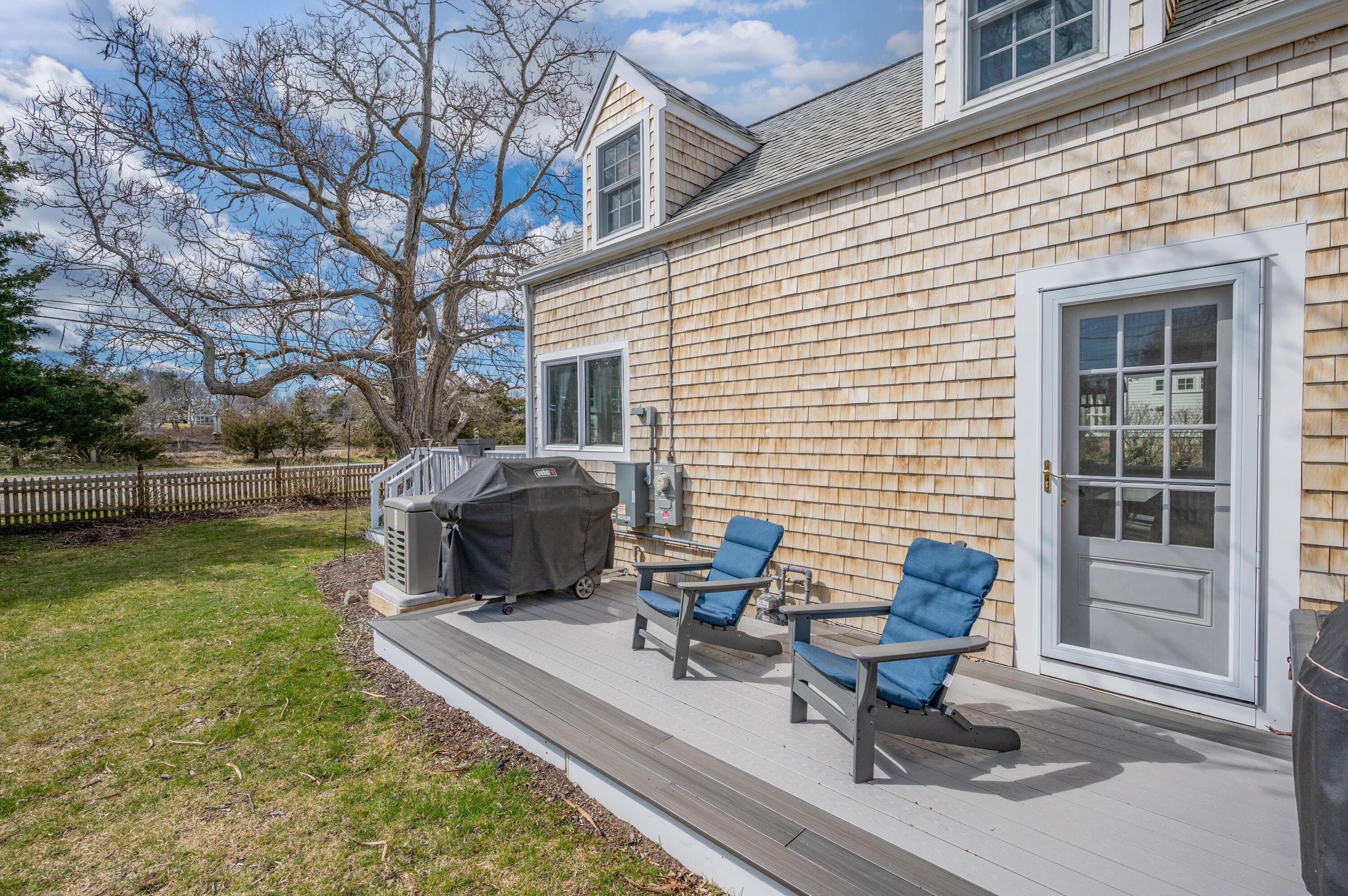 40 Commerce Road Barnstable, MA 02630 - Photo 26 of 43 a view of a backyard with table and chairs