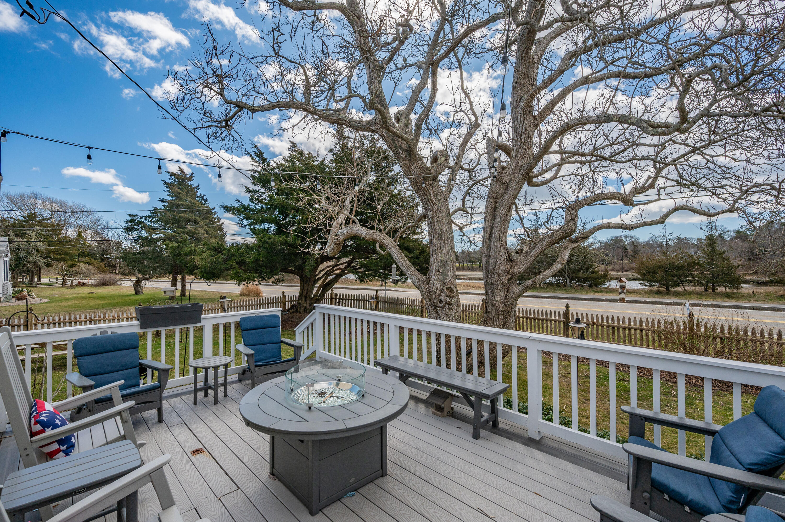 40 Commerce Road Barnstable, MA 02630 - Photo 29 of 43 a view of a patio with furniture and a yard
