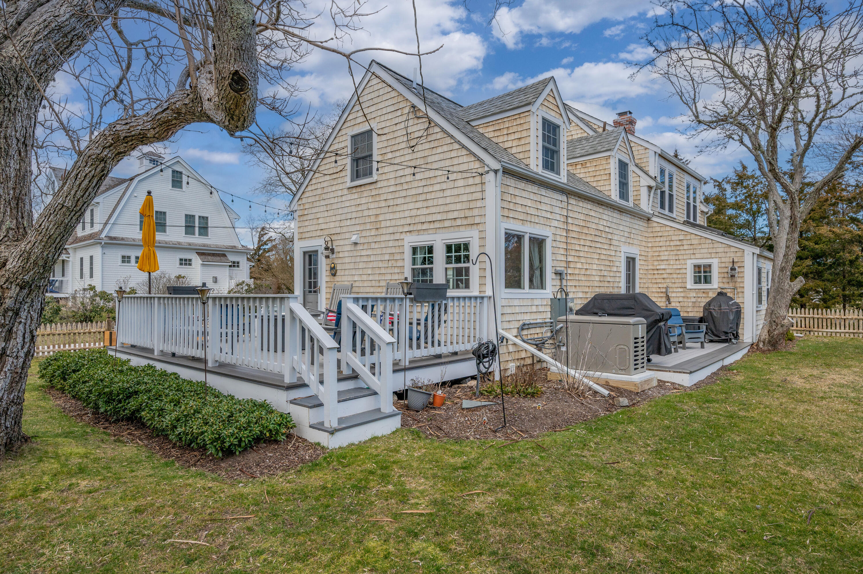 40 Commerce Road Barnstable, MA 02630 - Photo 30 of 43 a view of a house with a yard and deck
